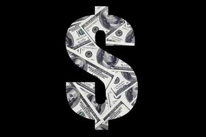 The symbol Dollar on a black background. A pattern from the set of scattered dollar bills as a filling character photo