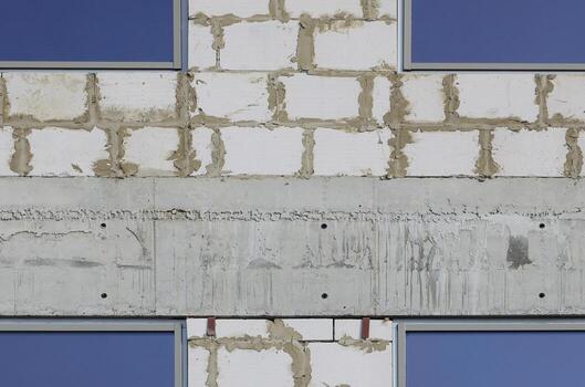 Fragment of an unfinished structure of a multi-storey building made of large concrete bricks photo