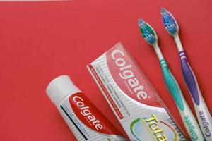 TERNOPIL, UKRAINE - JUNE 23, 2022 Colgate toothpaste and toothbrushes, a brand of oral hygiene products manufactured by American consumer-goods company Colgate-Palmolive photo