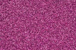 Pink decorative sequins. Background image with shiny bokeh lights from small elements photo
