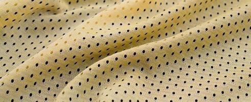 Yellow sport jersey clothing fabric texture and background with many folds photo