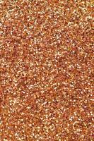 Orange decorative sequins. Background image with shiny bokeh lights from small elements photo