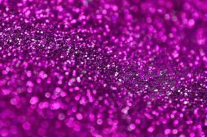 Pink decorative sequins. Background image with shiny bokeh lights from small elements photo