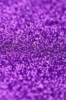 Purple decorative sequins. Background image with shiny bokeh lights from small elements