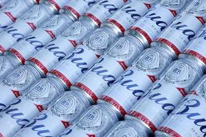 SUMY, UKRAINE - AUGUST 01, 2021 Many Cans of Budweiser Lager Alcohol Beer - Budweiser is a Brand from Anheuser-Busch Inbev photo