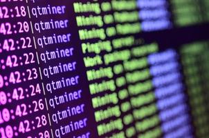 Macro snapshot of the program interface for crypto currency mining on the monitor of an office computer. The concept of mining bitcoins. The flow of information strings and data photo