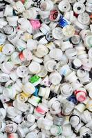 A pattern of many used and soiled nozzles from spray cans with aerosol paint. Background texture of the street art of drawing graffiti on the walls photo