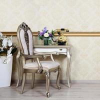 A fragment of a retro interior with a chair and a desk on which is located a telephone and a vase of flowers photo