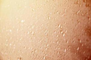 Background image of rain drops on a glass window. Macro photo with shallow depth of field. Toned picture