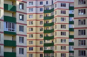 New or recently completed multi-storey residential building with windows and balconies. Russian type of house building photo