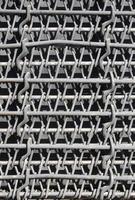 Metal multilayered thick grid of black color. Composite texture photo