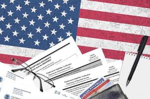 USCIS form I-9 Employment eligibility verification lies on flat lay office table and ready to fill. U.S. Citizenship and Immigration services paperwork concept photo