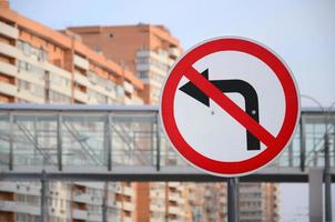 Turn left is prohibited. Traffic sign with crossed out arrow to the left photo