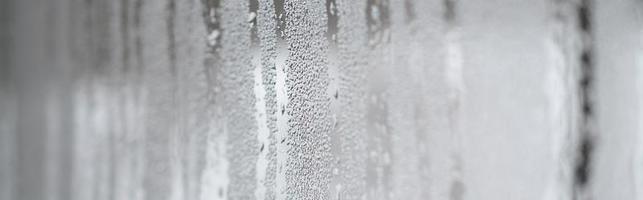 The texture of a misted glass with a lot of drops and condensation flows. Background image photo