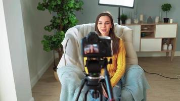 Beautiful Girl Blogger Filming Her Video Blog. Female Influencer Creates Online Training Course for Remote Work. Attractive Woman in Yellow Sweater Blogging. Distance Education and E-learning Concept.