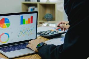 Businessman working at office with document on his desk.Paperwork graph report planning analyzing the financial and investment analysis concept. photo