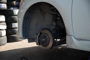 Change a car tire caused by a flat tire by using a jack to lift the car. photo