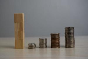 Stack coin and wood block cube blank on desk. photo