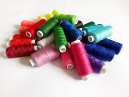 colored threads for sewing on a white background photo