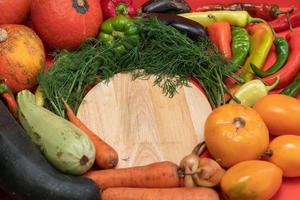Vegetables are laid out around empty place. Empty space for text. Vegetables on a wooden board. photo