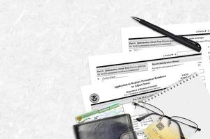 La solicitud del formulario uscis i-485 para registrar la residencia permanente o ajustar el estado se encuentra en una mesa de oficina plana y lista para llenar. concepto de papeleo de los servicios de ciudadanía e inmigración de los estados unidos foto