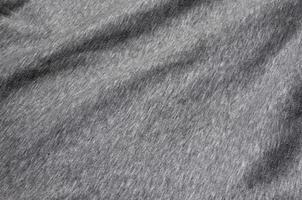 primer plano de calentador arrugado y jersey deportivo de punto o tela con capucha fondo de tela texturizada con un delicado patrón de rayas foto