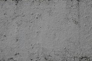 Texture of the old embossed concrete wall in gray color. Background image of a concrete product photo