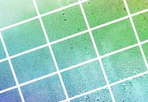 A collage of many different fragments of glass, decorated with rain drops from the condensate. Spring tones with green and blue colors photo