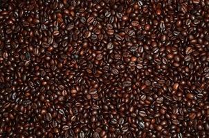 Background texture of a huge number of fragrant and fresh brown roasted coffee grains photo