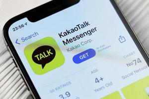 KHARKOV, UKRAINE - MARCH 5, 2021 KakaoTalk Messenger icon and application from App store on iPhone 12 pro display screen on white table photo