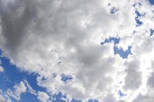 A blue sky with lots of white clouds of different sizes. Fisheye photo