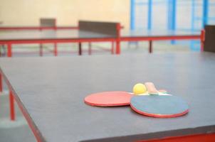 rackets and ball on Ping pong table in outdoor sport yard. Active sports and physical training concept photo