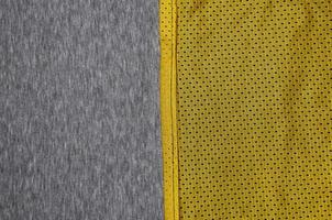 Top view of cloth textile surface. Close-up rumpled heater and knitted fabric texture with a thin striped pattern. Sport clothing fabric texture. Colored basketball shirt and heater hoodie photo