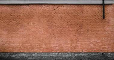 The texture of the brick wall of many rows of bricks painted in brown color photo