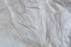 White crumpled paper blank background surface. Pastels book cover paint top view Gray grunge surface empty parchment sheet. Art poster above folds angle craft focus light scene photo