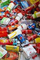 KHARKOV, UKRAINE - JULY 2, 2021 Many wrappings and cans from used products by famous worldwide brands. Pattern of trash of various colors and materials photo