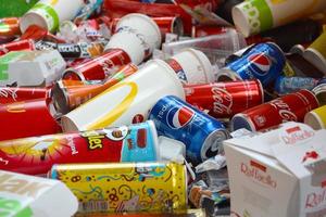 KHARKOV, UKRAINE - JULY 2, 2021 Many wrappings and cans from used products by famous worldwide brands. Pattern of trash of various colors and materials photo