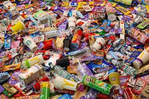 KHARKOV, UKRAINE - AUGUST 10, 2021 Big pile of various wrappings and empty disposable packages and cups from famous branded food production photo