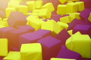 Many colorful soft blocks in a kids' ballpit at a playground photo