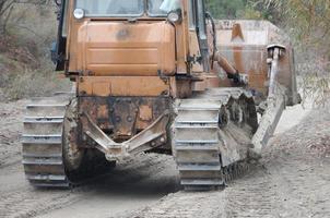 Quarry aggregate with heavy duty machinery. Caterpillar loader Excavator with backhoe driving to construction site quarry photo