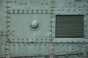 The texture of the wall of the tank, made of metal and reinforced with a multitude of bolts and rivets. Images of the covering of a combat vehicle from the Second World War photo