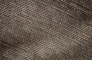 The texture of a very old brown sack cloth. Retro texture with canvas material. Background image with copy space photo