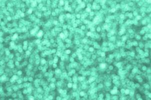 A huge amount of decorative sequins. Background image with shiny bokeh lights from small elements photo
