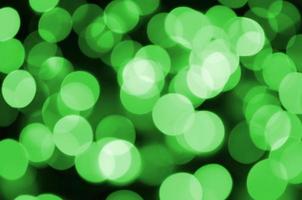 Green abstract Christmas blurred luminous background. Defocused artistic bokeh lights image photo