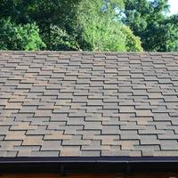 Modern roofing and decoration of chimneys. Flexible bitumen or slate shingles photo