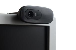 A modern web camera is installed on the body of a flat screen monitor. Device for video communication and recording of high quality video photo