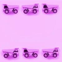 Many small purple toy trucks on texture background of fashion pastel purple color paper photo