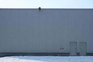 Texture of a high metal wall of an industrial building without windows photo