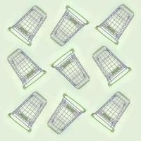 Pattern of many small shopping carts on a lime background photo