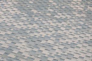 Background mosaic texture of flat roof tiles with bituminous coating photo